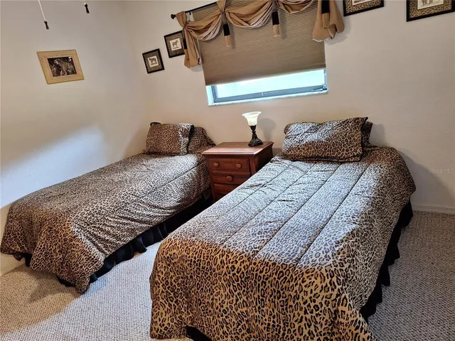 a bedroom with two beds and painting on the wall