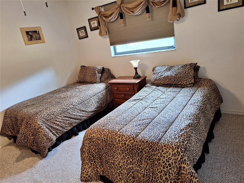 2223 Tinker Street Port Charlotte, FL 33948 - Photo 12 of 23 a bedroom with two beds and painting on the wall