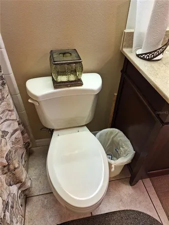 a bathroom with a toilet and a mirror