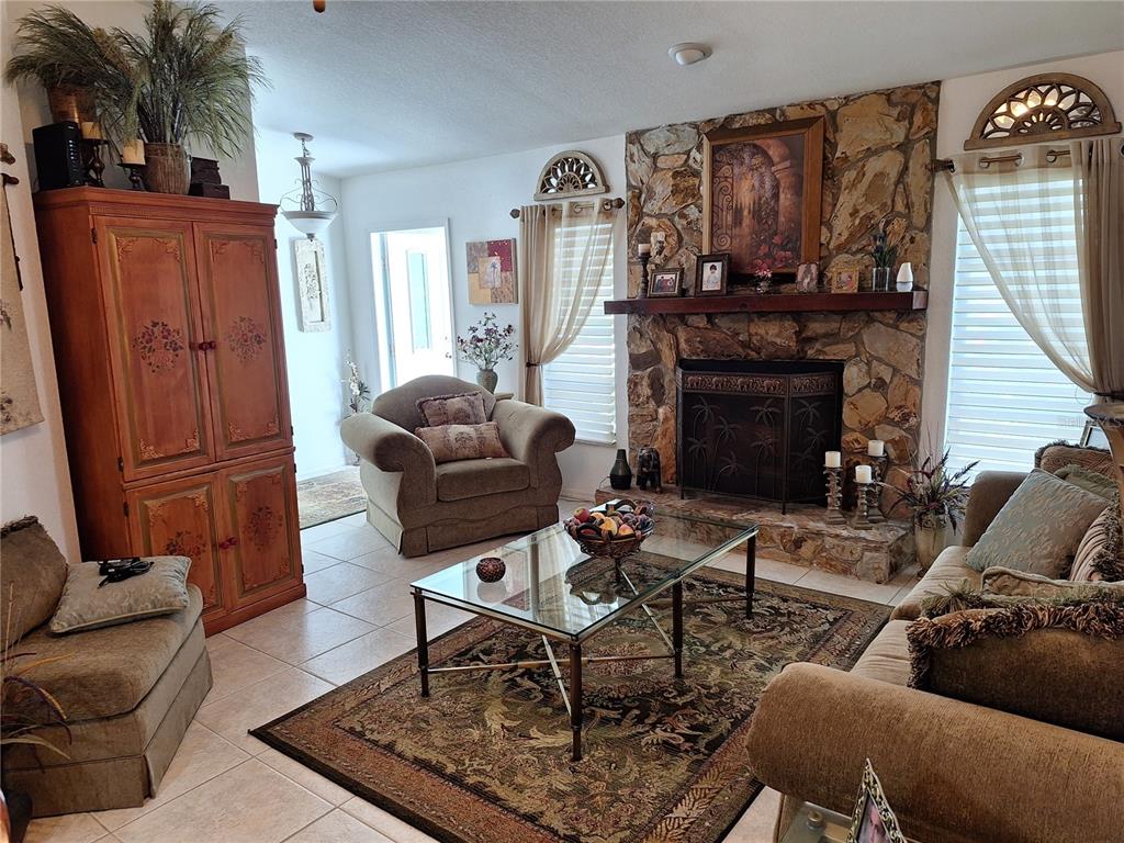 2223 Tinker Street Port Charlotte, FL 33948 - Photo 19 of 23 a living room with furniture a fireplace and a flat screen tv