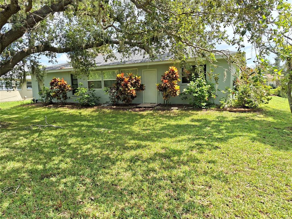 2223 Tinker Street Port Charlotte, FL 33948 - Photo 22 of 23 a front view of a house with garden