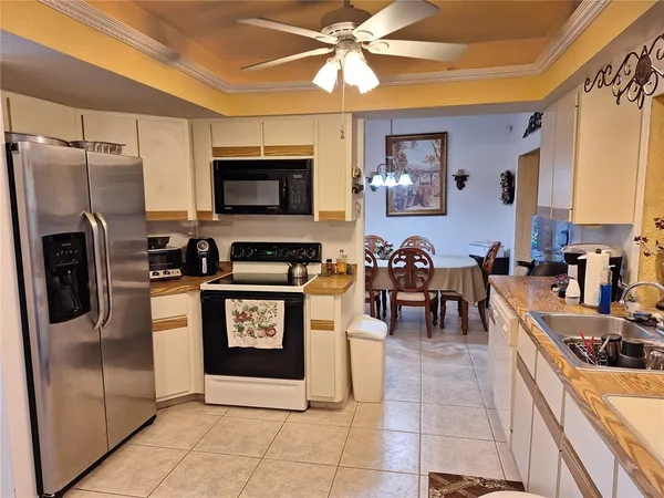 a kitchen with stainless steel appliances granite countertop a refrigerator a stove top oven a sink and dishwasher