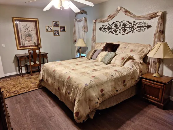 a large bed sitting in a bedroom next to a window