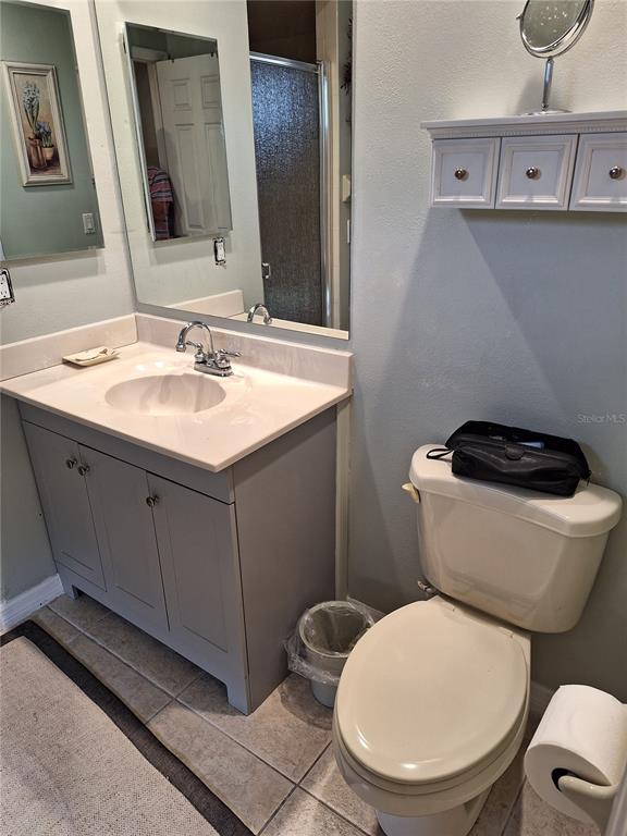 2223 Tinker Street Port Charlotte, FL 33948 - Photo 9 of 23 a bathroom with a toilet a sink and mirror