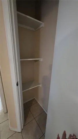 a view of a utility room with cabinets