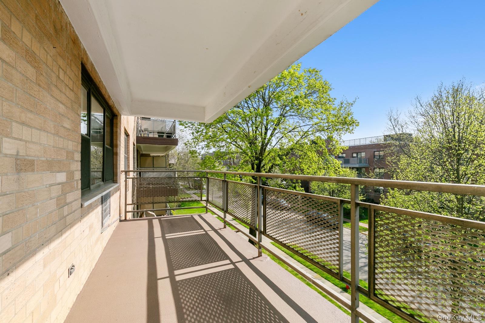 40 Stoner Avenue, Unit 2F Great Neck, NY 11021 - Photo 5 of 15 a view of balcony with floor to ceiling windows and wooden floor