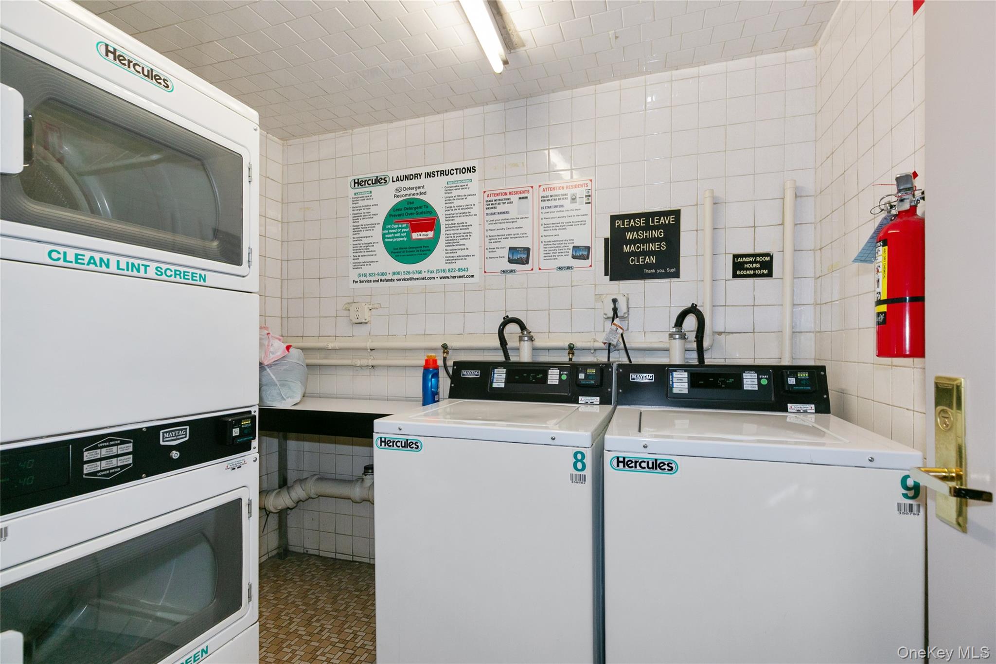 40 Stoner Avenue, Unit 2F Great Neck, NY 11021 - Photo 8 of 15 a kitchen with stainless steel appliances a sink and a microwave