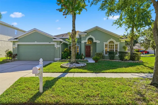 a front view of a house with a yard and garage