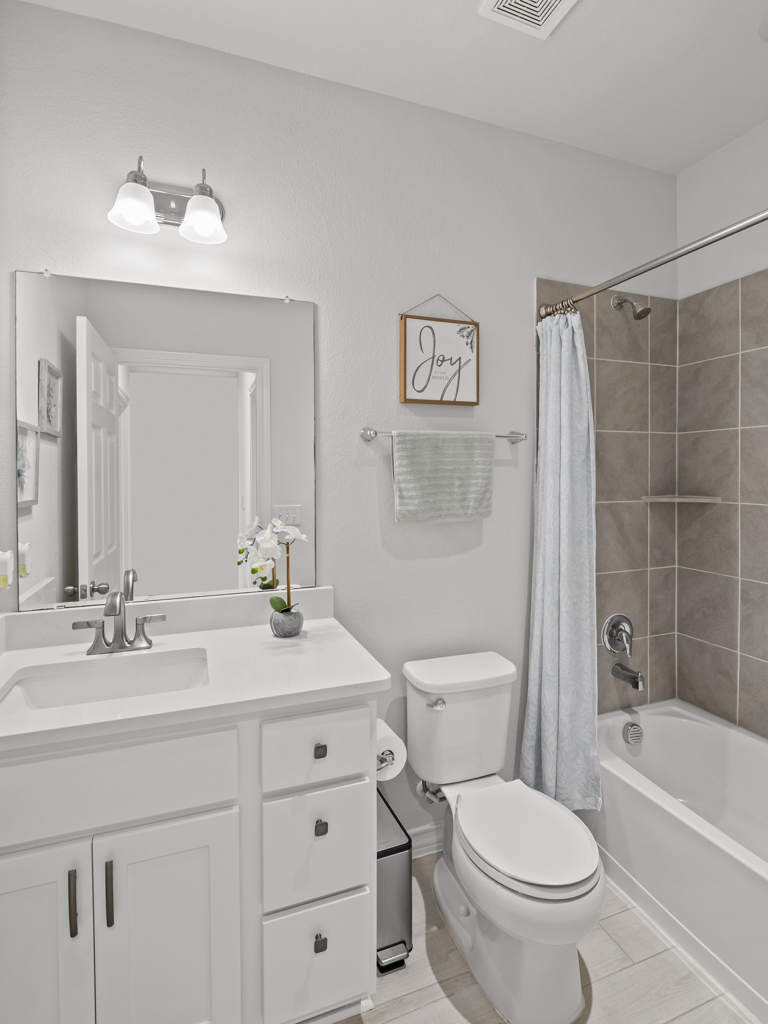 353 Capstone Road Liberty Hill, TX 78642 - Photo 17 of 28 A well-appointed bathroom offers pristine white fixtures and a tiled shower for daily comfort.