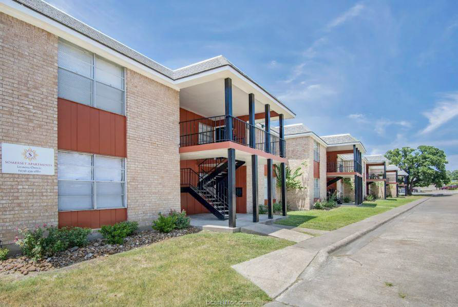 a view of a building with a yard