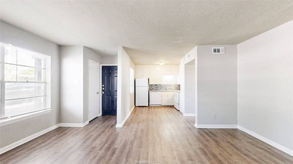 3800 East 29th Street, Unit 18 Bryan, TX 77802 - Photo 12 of 22 a view of a kitchen with wooden floor and a sink