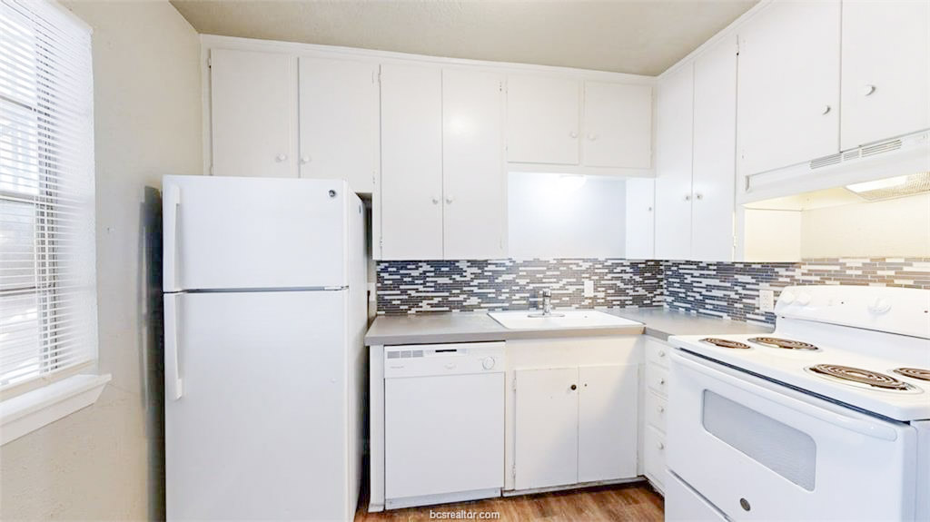 3800 East 29th Street, Unit 18 Bryan, TX 77802 - Photo 10 of 22 a white refrigerator freezer sitting inside of a kitchen