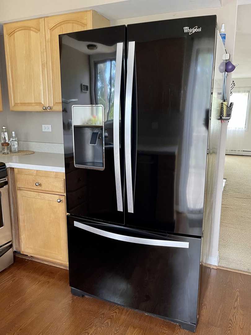 396 Echo Lane, Unit 3 Aurora, IL 60504 - Photo 6 of 20 a kitchen with metallic refrigerator and white cabinets
