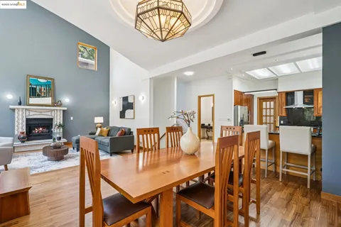 a view of a dining room with furniture a chandelier and wooden floor