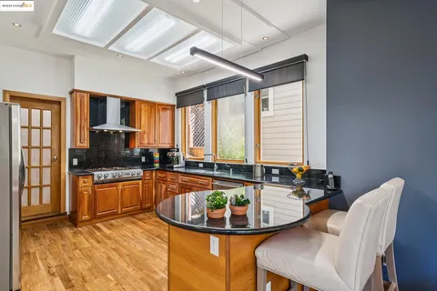 a kitchen with granite countertop a sink and a stove