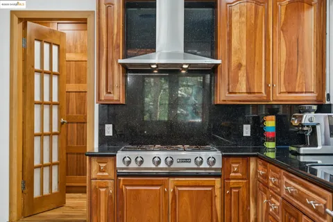 a stove top oven sitting inside of a kitchen