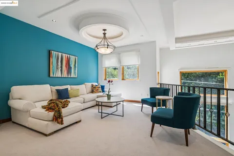 a living room with furniture a chandelier and a window