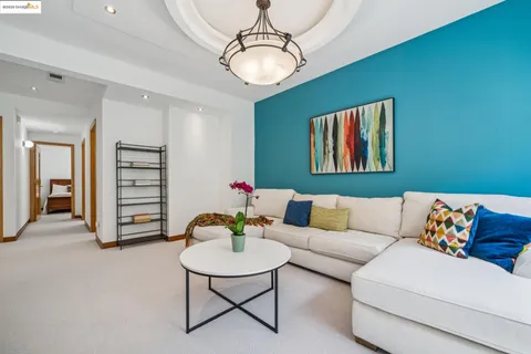 a living room with furniture and a chandelier