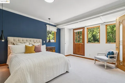 a bedroom with furniture and a flat screen tv