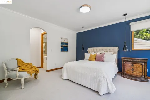 a bathroom with a tub a sink and a window