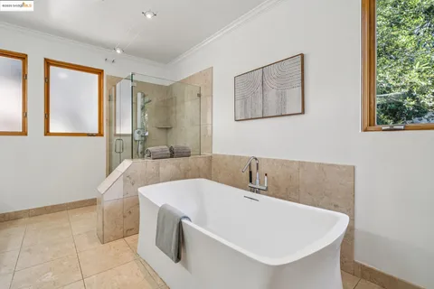a bathroom with a tub sink and shower