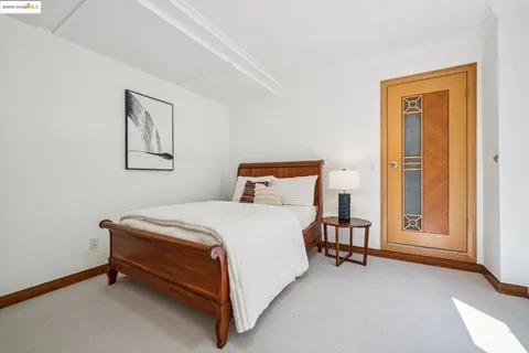 a bedroom with a bed and a night stand