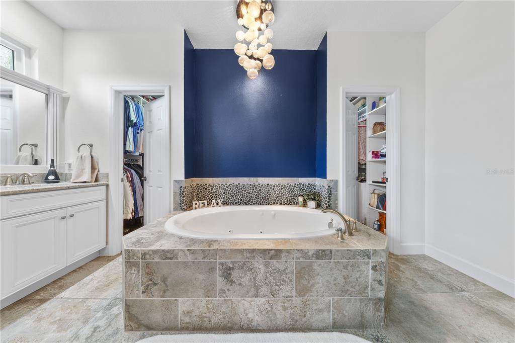 16948 Deer Island Road Tavares, FL 32778 - Photo 20 of 67 a bathroom with a tub sink and mirror