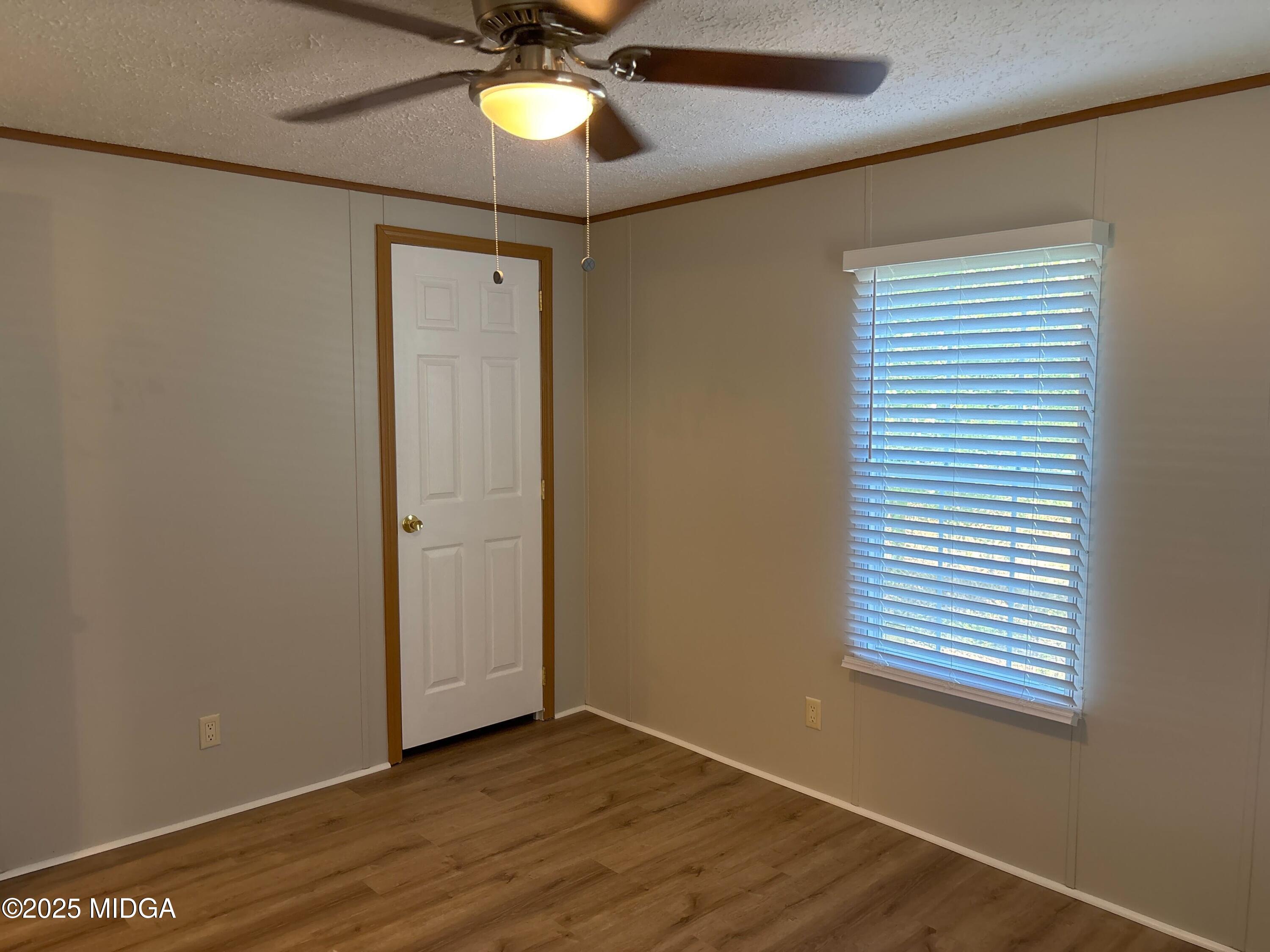 137 Alview Drive Macon, GA 31206 - Photo 17 of 22 a view of an empty room with a window and wooden floor