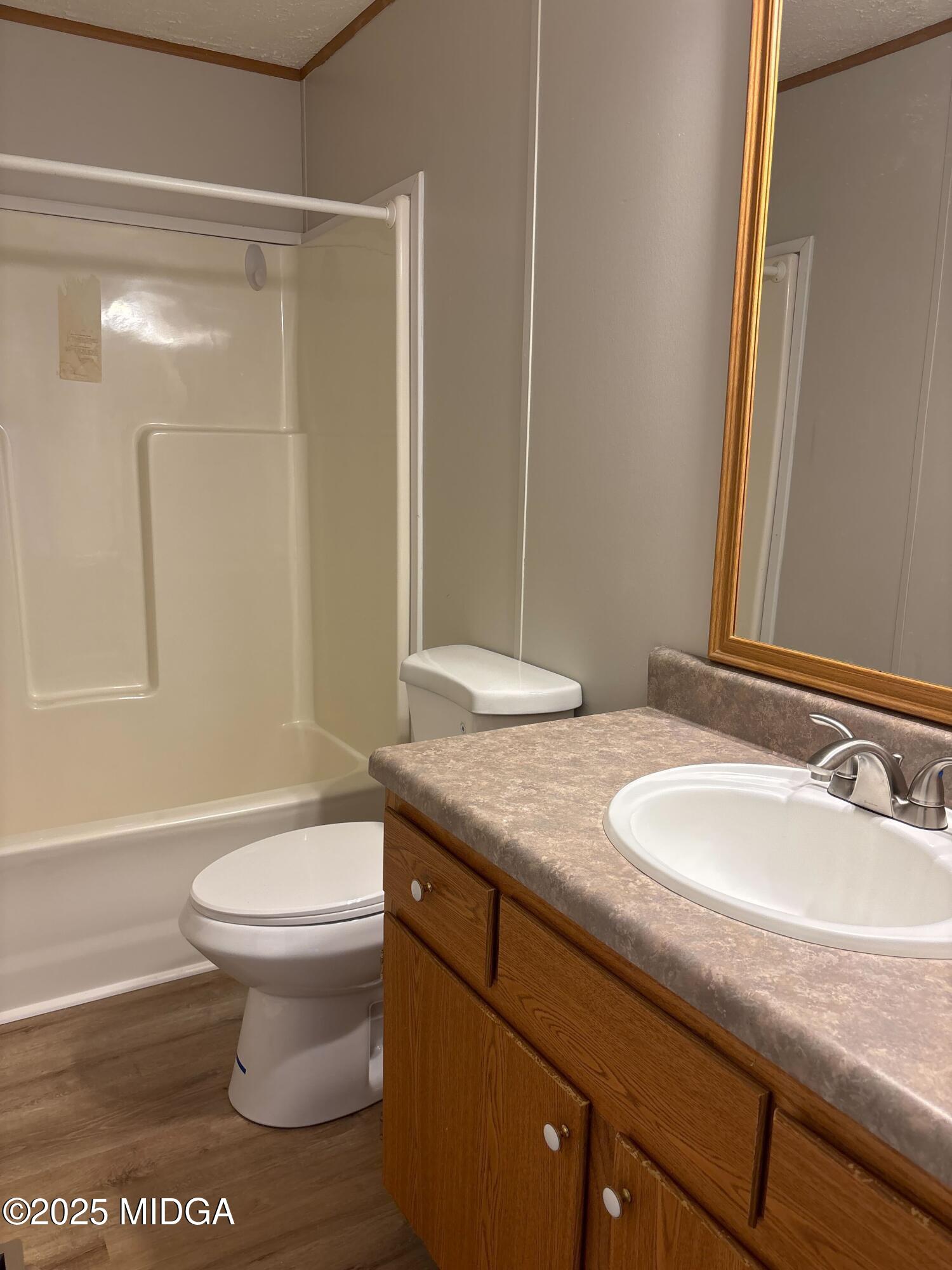 137 Alview Drive Macon, GA 31206 - Photo 18 of 22 a bathroom with a granite countertop sink a toilet a mirror and shower