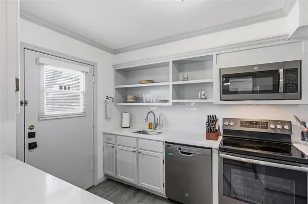 a kitchen with a refrigerator stove and microwave
