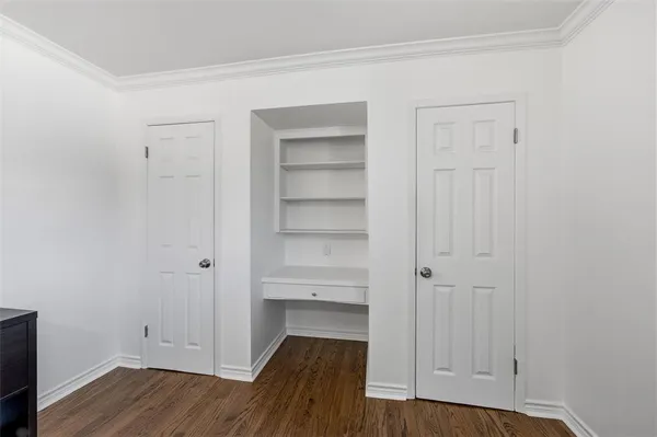 a view of walk in closet with wooden floor