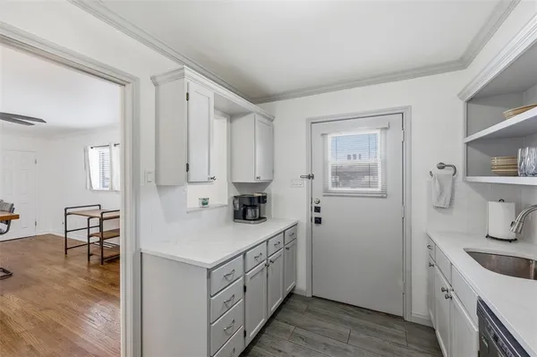 a kitchen with sink cabinets and wooden floor