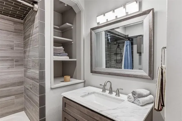 a bathroom with a sink vanity and mirror