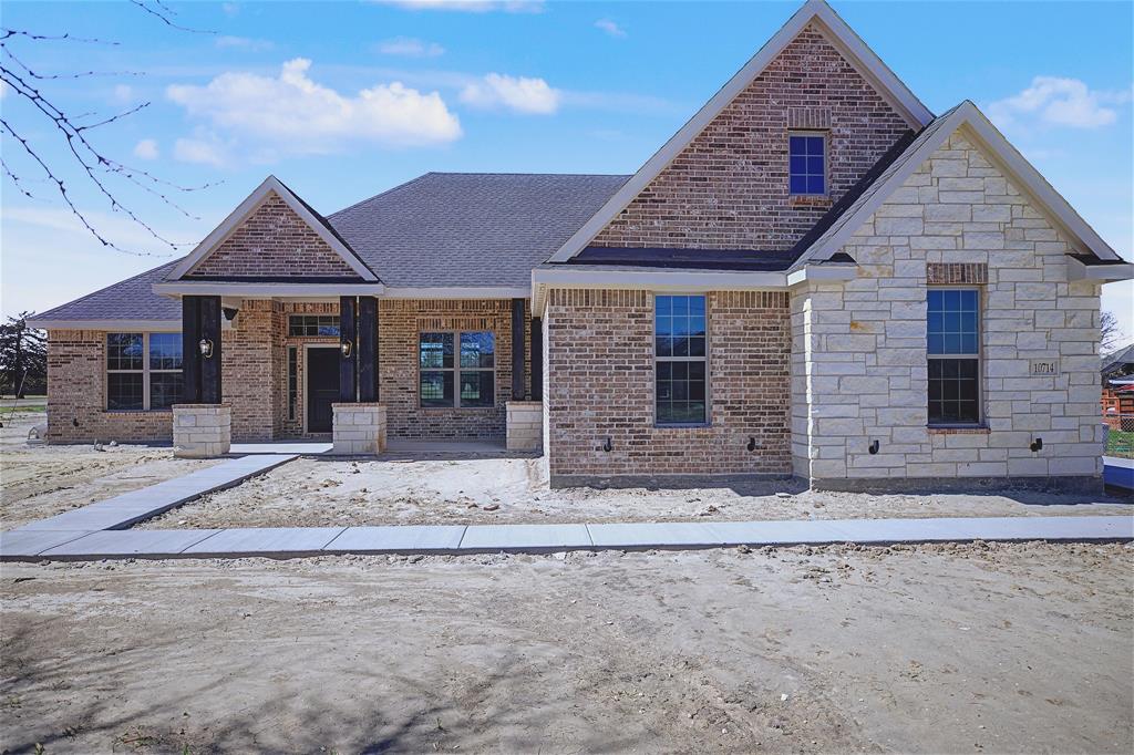 44 Karol Jean Way Quinlan, TX 75474 - Photo 1 of 36 View of front facade with covered porch, brick siding, roof with shingles, and stone siding