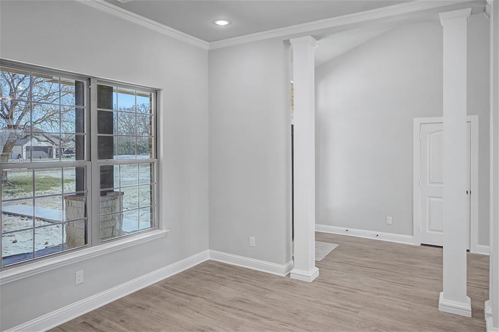44 Karol Jean Way Quinlan, TX 75474 - Photo 14 of 36 Empty room featuring ornate columns, crown molding, light wood-type flooring, and recessed lighting