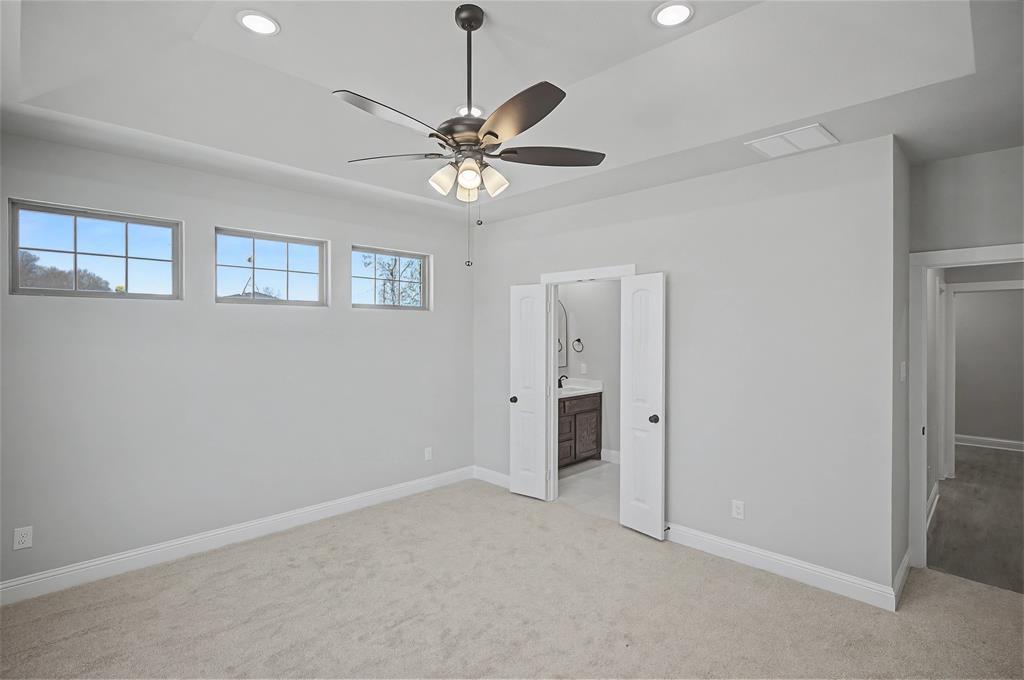 44 Karol Jean Way Quinlan, TX 75474 - Photo 15 of 36 Unfurnished bedroom featuring light colored carpet, recessed lighting, a ceiling fan, and ensuite bathroom