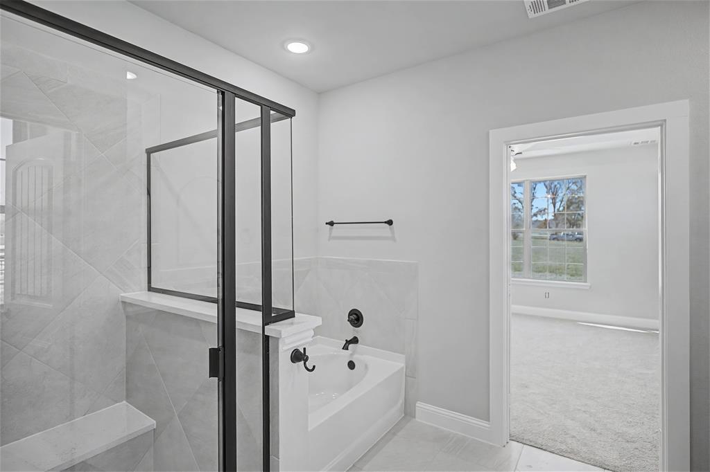 44 Karol Jean Way Quinlan, TX 75474 - Photo 17 of 36 Full bath with a garden tub, a stall shower, light colored carpet, and light tile patterned flooring