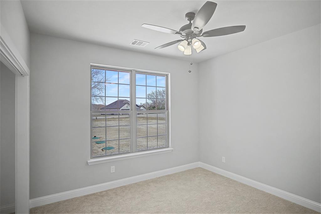 44 Karol Jean Way Quinlan, TX 75474 - Photo 23 of 36 Spare room featuring a ceiling fan and light carpet