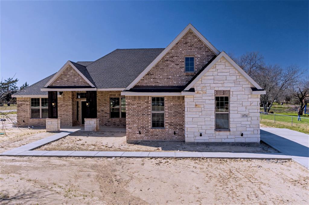 44 Karol Jean Way Quinlan, TX 75474 - Photo 25 of 36 View of front of house with stone siding, brick siding, and a shingled roof