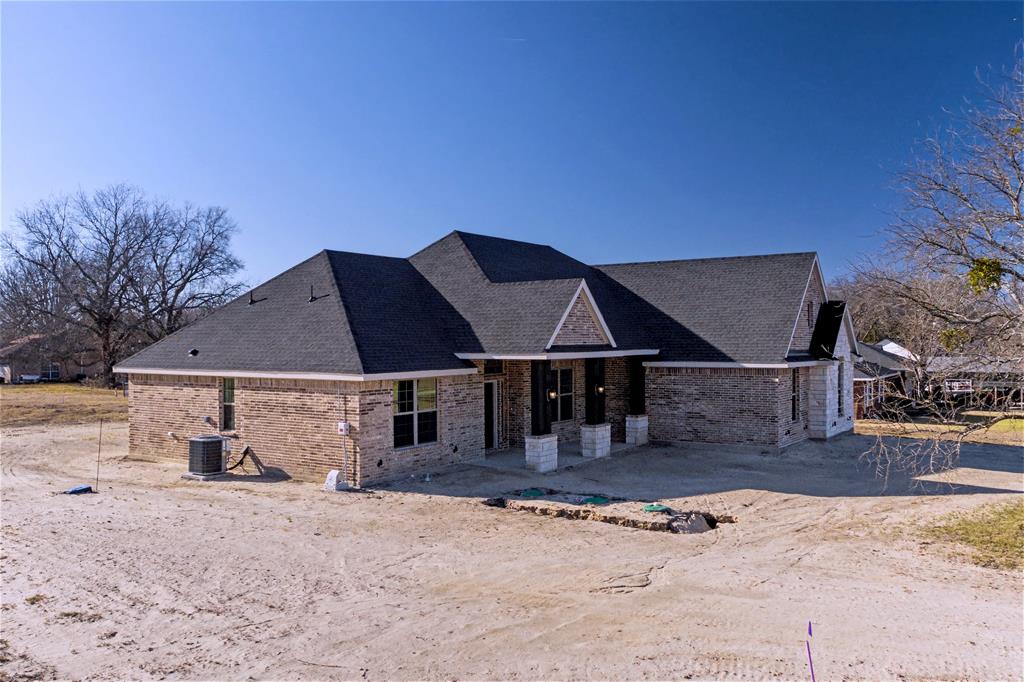 44 Karol Jean Way Quinlan, TX 75474 - Photo 26 of 36 Back of house with brick siding and a shingled roof
