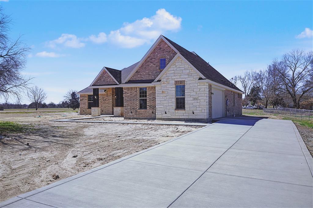 44 Karol Jean Way Quinlan, TX 75474 - Photo 4 of 36 View of front facade with brick siding, stone siding, a garage, and driveway