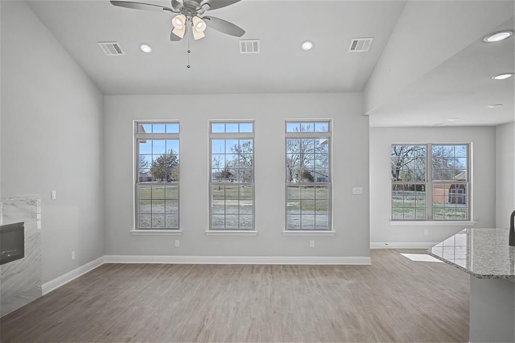 44 Karol Jean Way Quinlan, TX 75474 - Photo 9 of 36 Unfurnished living room with a ceiling fan, light wood-style flooring, recessed lighting, and a fireplace