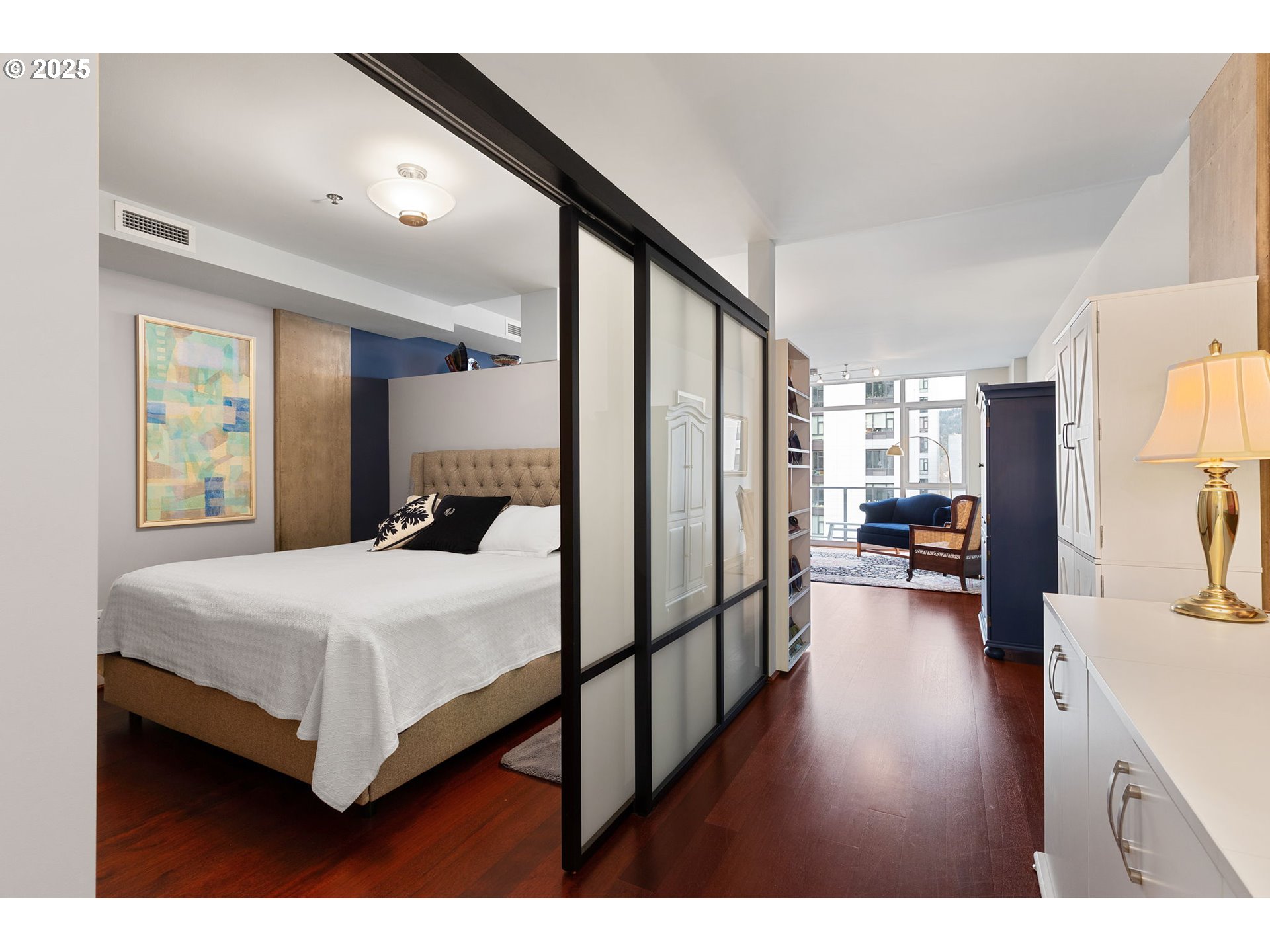 1221 Southwest 10th Avenue, Unit 809 Portland, OR 97205 - Photo 5 of 39 a bedroom with a bed furniture and a large window