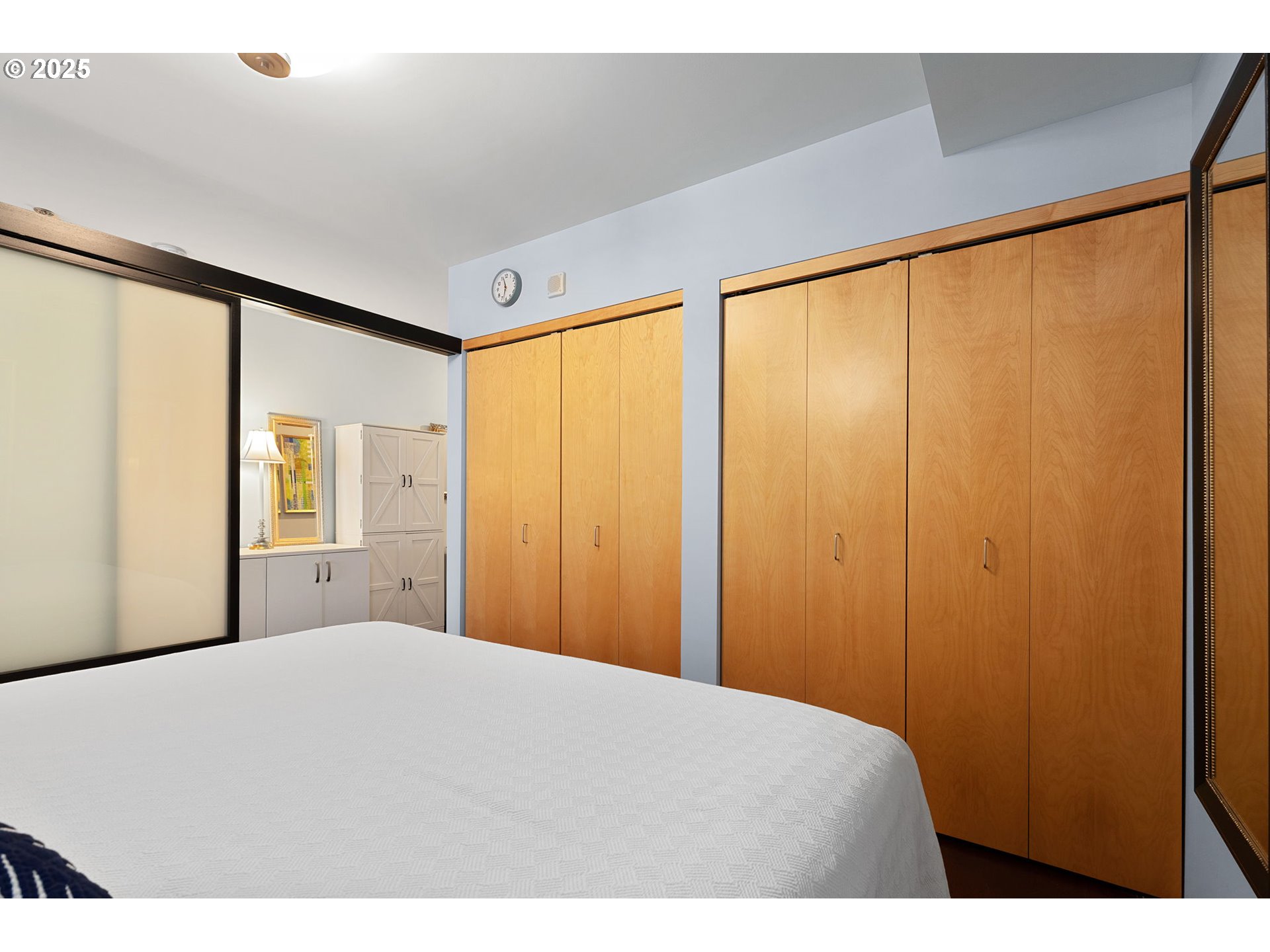 1221 Southwest 10th Avenue, Unit 809 Portland, OR 97205 - Photo 7 of 39 a bedroom with a large window and a bed