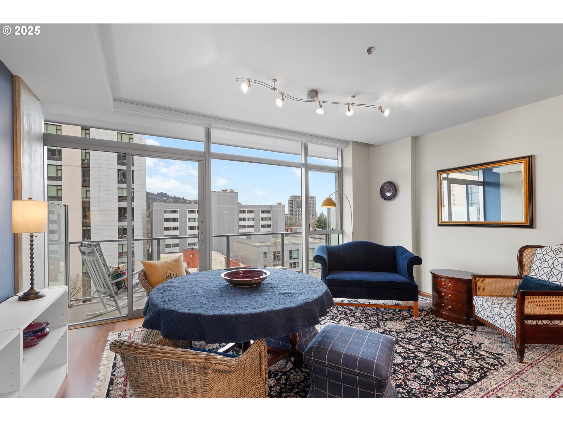 1221 Southwest 10th Avenue, Unit 809 Portland, OR 97205 - Photo 10 of 39 a living room with furniture a large window and a flat screen tv