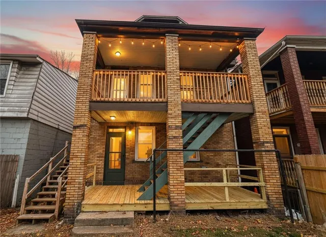 a view of a balcony with stairs and wooden floor