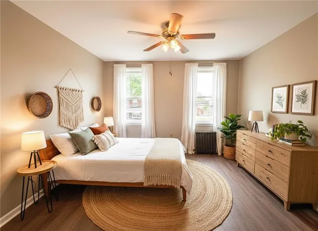 a view of an empty room with wooden floor and window