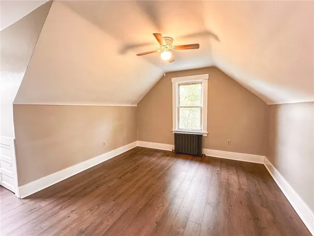 a bedroom with a bed and a potted plant