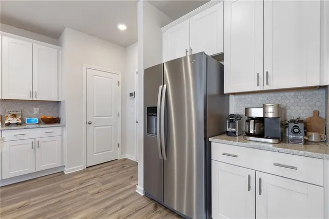 a kitchen with stainless steel appliances granite countertop white cabinets sink and granite counter tops