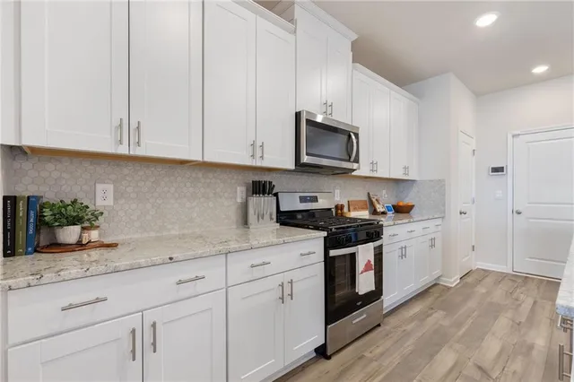 a kitchen with kitchen island a sink stove and refrigerator